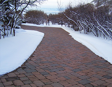 A heated paver driveway after a snowstorm.